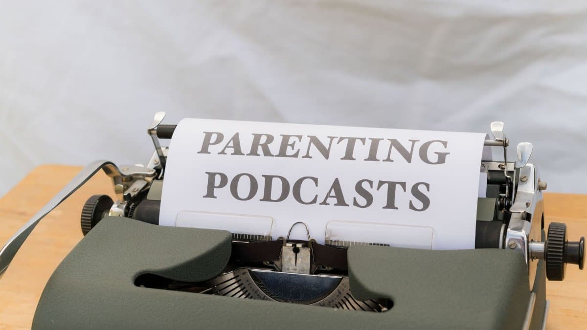 A classic typewriter with a sheet labeled 'Parenting Podcasts' set against a neutral background.