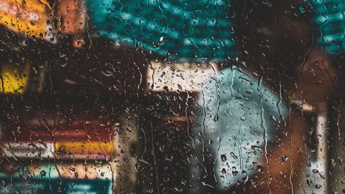 Blurred view through a rain-soaked window capturing the vibrant essence of Kolkata's streets.