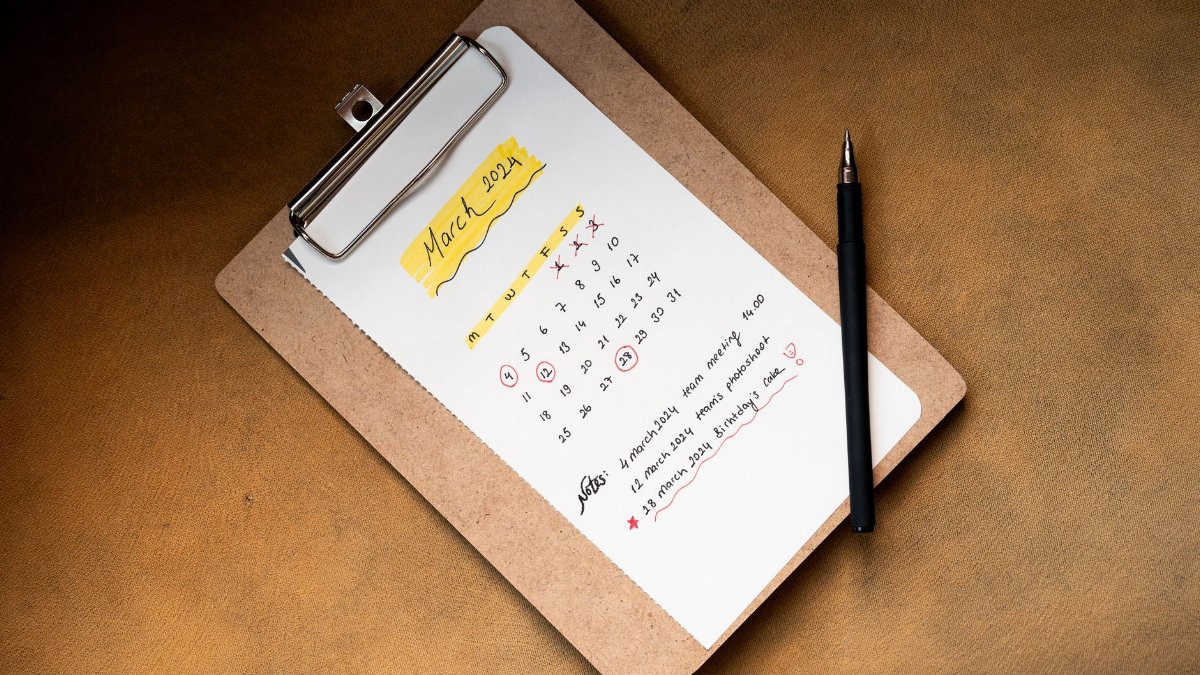 Top view of a March 2024 calendar on a clipboard with a pen, ideal for planning or scheduling content.