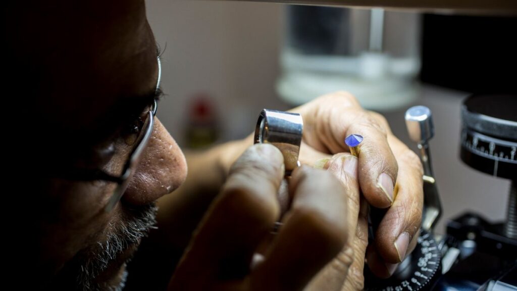 Close-up of a jeweler inspecting a gemstone in Dubai, highlighting precision and craftsmanship.