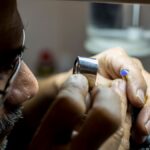 Close-up of a jeweler inspecting a gemstone in Dubai, highlighting precision and craftsmanship.