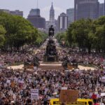 Large protest at Eakins Oval in Philadelphia, highlighting activism and unity.