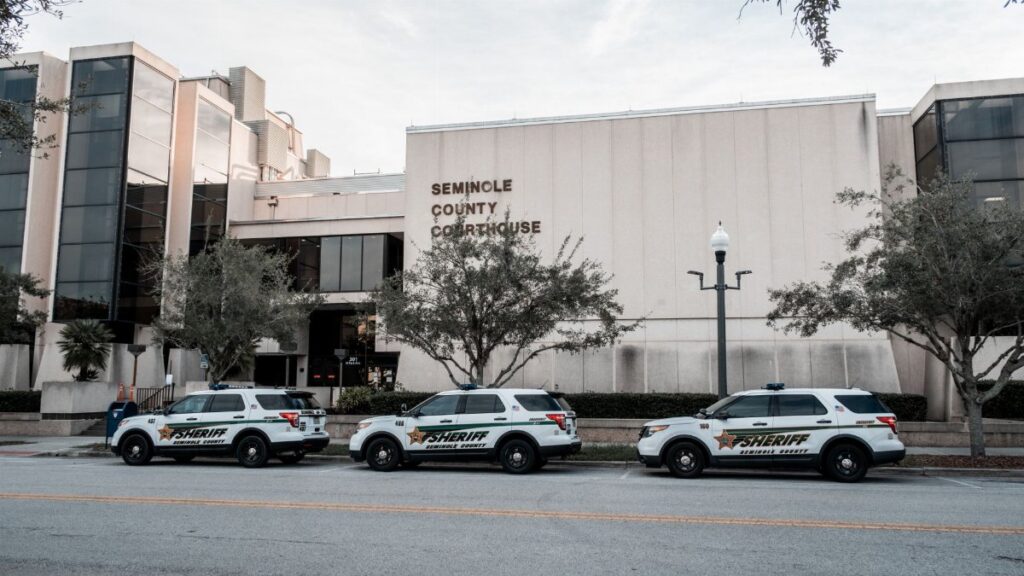 Sheriff vehicles parked in front of Seminole County Courthouse during the day.