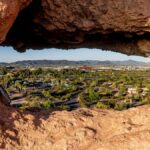 Capture of Phoenix cityscape through a unique rock formation in Papago Park, Arizona.
