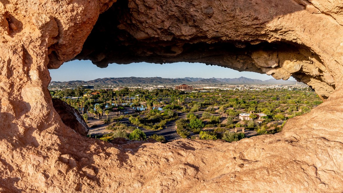 Capture of Phoenix cityscape through a unique rock formation in Papago Park, Arizona.