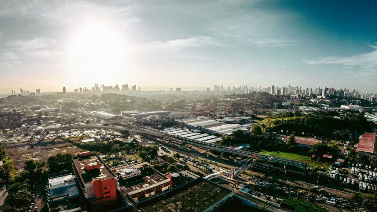 Expansive aerial cityscape of San Miguelito in Panama, featuring urban landscapes and sunlight.