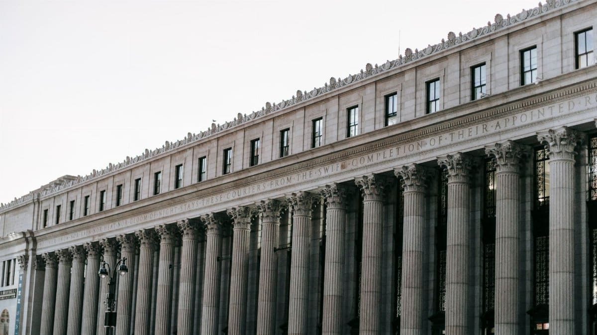 From below of facade of famous James A Farley Post Office with columns and windows in center of New York at daytime