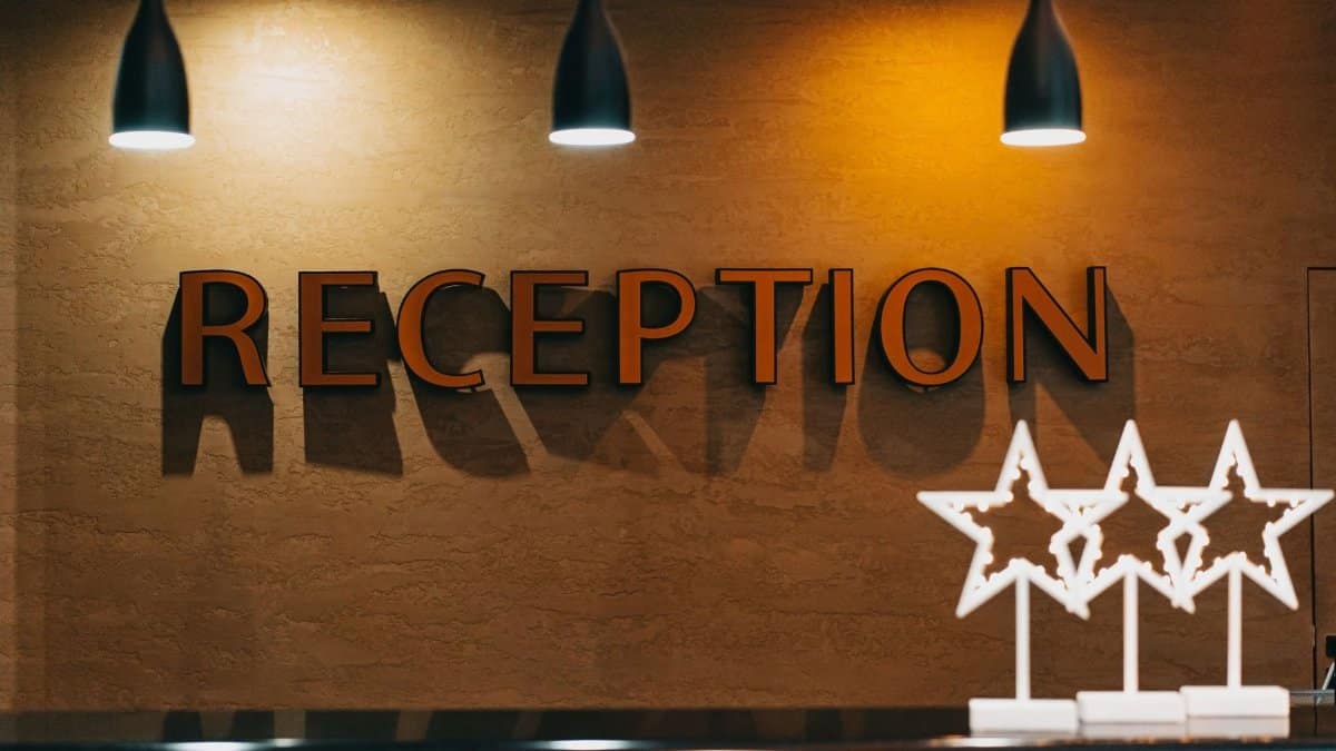 Elegant hotel reception area with illuminated signage and decor.