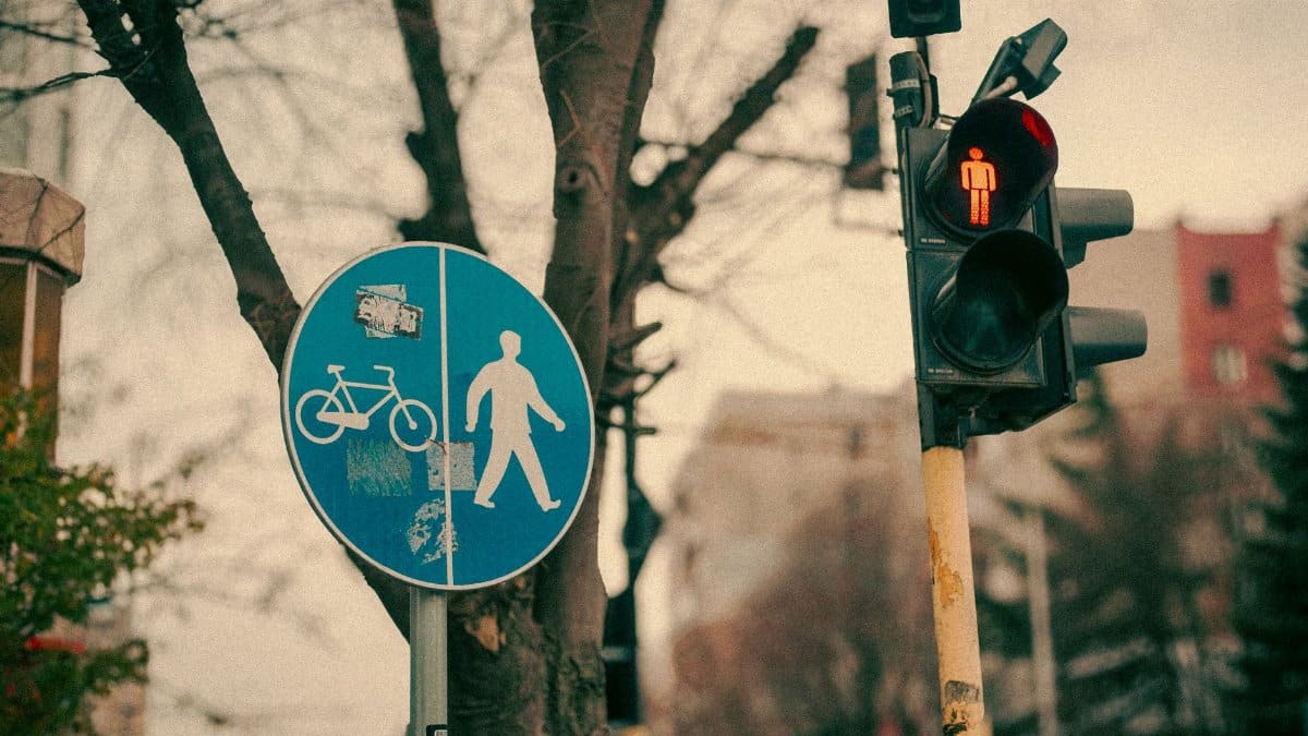 A traffic light and pedestrian sign in Varna, Bulgaria, showcasing an urban winter scene.