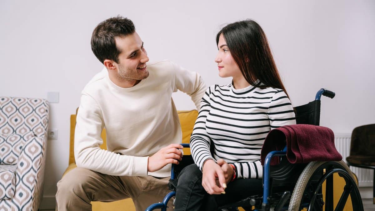 A loving couple sharing a heartfelt moment, showcasing support and connection despite physical challenges.