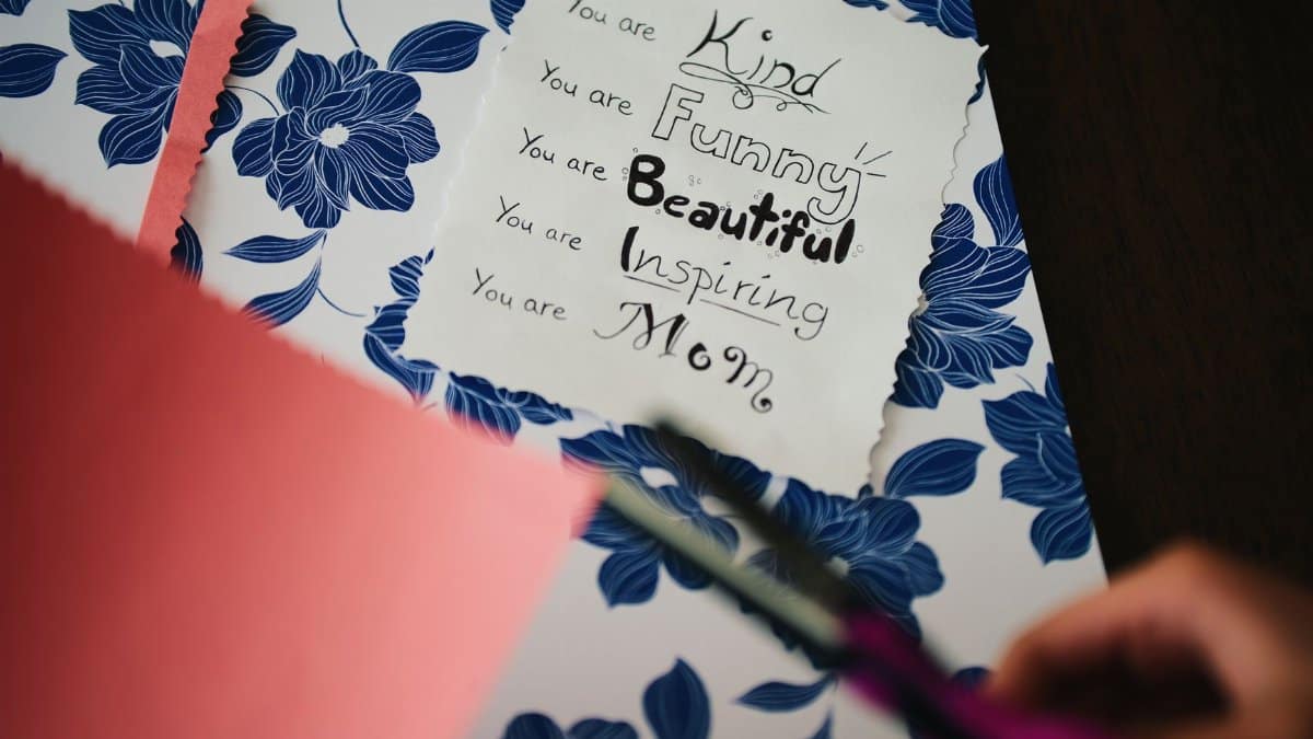 A beautifully crafted card celebrates motherhood with floral patterns and a heartfelt message.