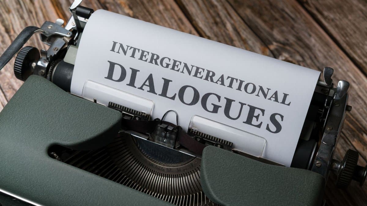 Close-up of a vintage typewriter with paper reading 'Intergenerational Dialogues'.