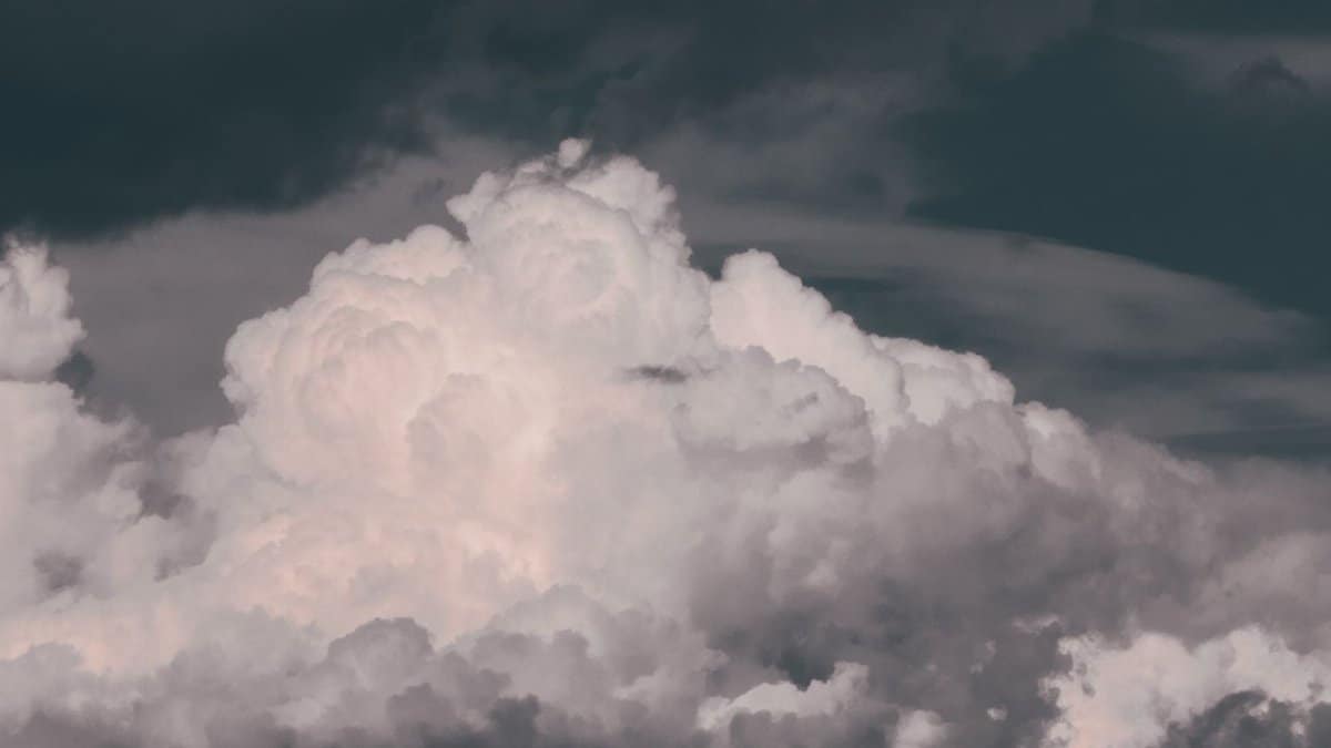 A captivating scene of thick fluffy clouds in a dramatic sky, evoking a sense of wonder.