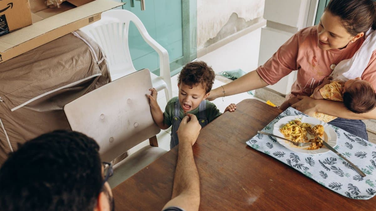 A family enjoys a meal together at a dining table, depicting a warm and intimate family moment.