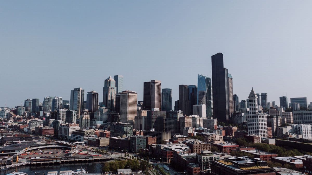 Explore Seattle's iconic skyline with modern skyscrapers under a clear, blue sky.