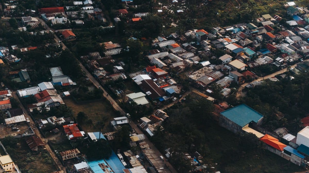 Vibrant aerial view capturing a densely built urban area with colorful rooftops and greenery.