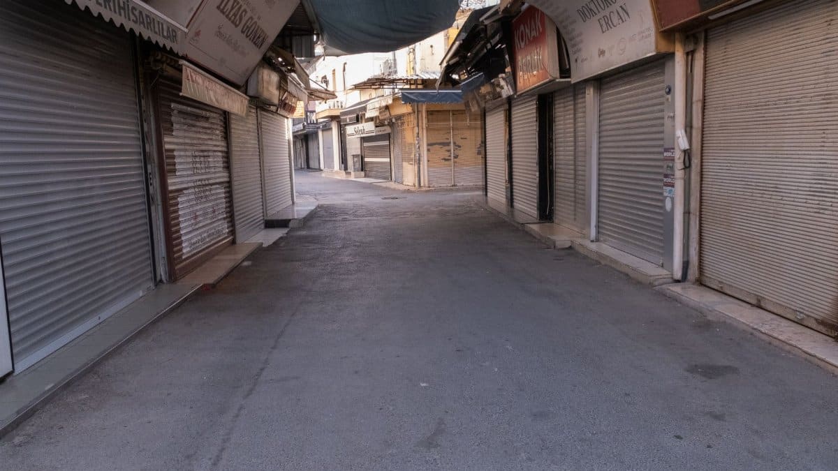 A quiet, empty street market with closed shops in İzmir, Türkiye, showcasing urban tranquility.
