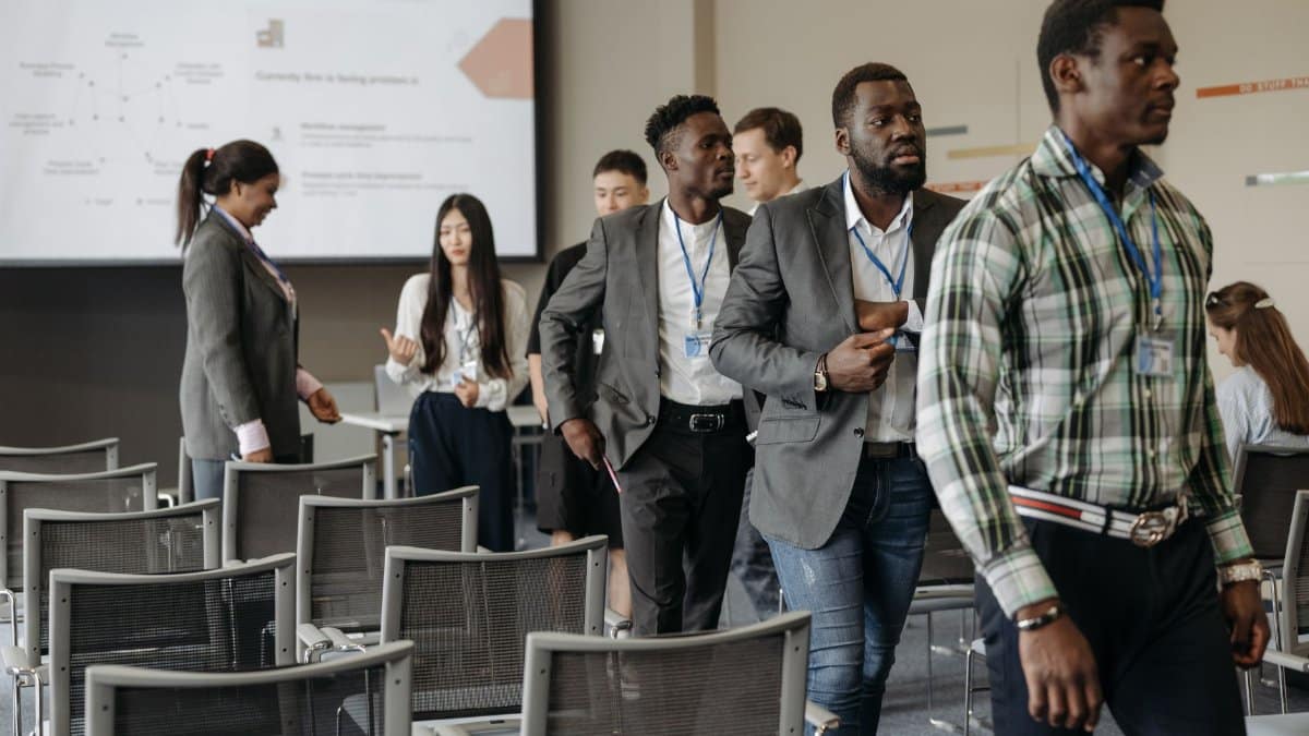 Diverse group of professionals attending a business conference in a modern conference room.