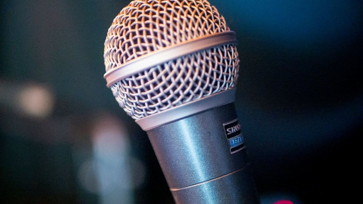 Detailed view of a performance microphone in an indoor setting.