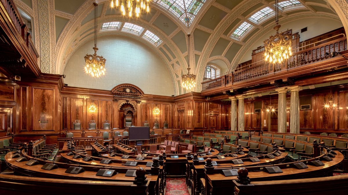 A beautifully designed chamber room with ornate woodwork and chandeliers in the UK.