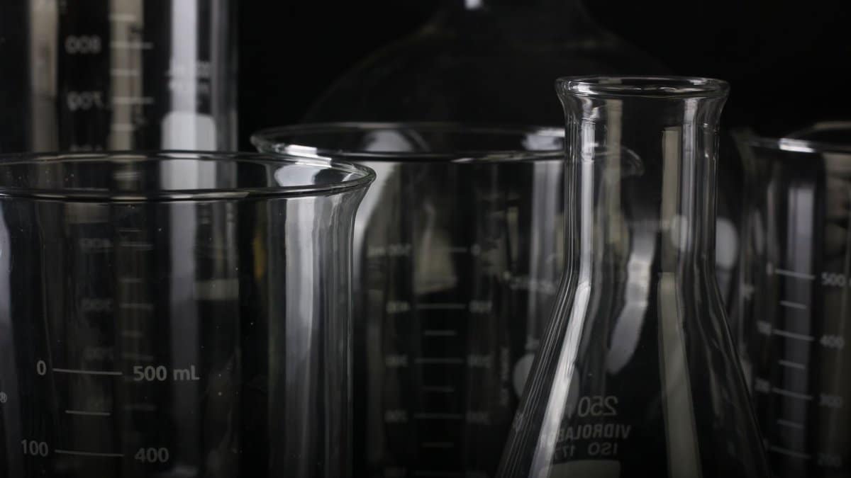 A detailed close-up of various transparent laboratory glassware used in scientific experiments.