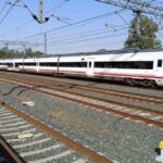 High-speed train at Jerez de la Frontera railway station, sunny day.