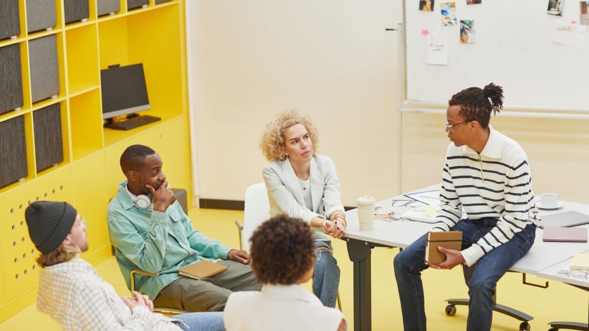 A diverse group engaged in a creative brainstorming session in a modern office setting.