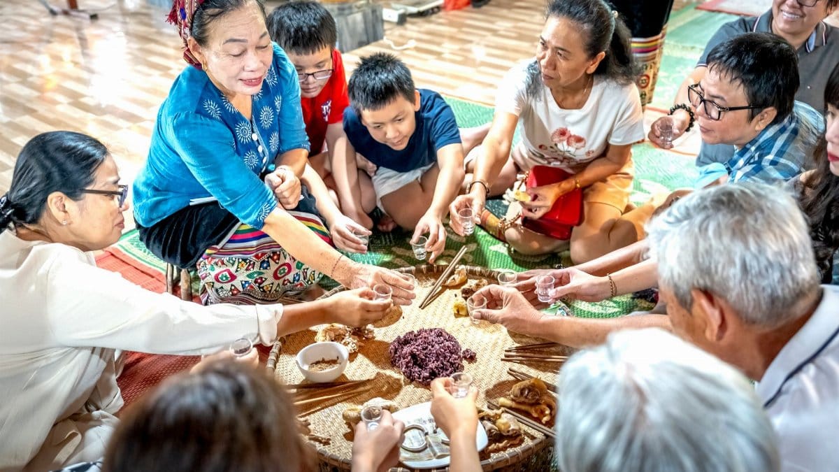A diverse group sharing a traditional meal, highlighting cultural traditions indoors.