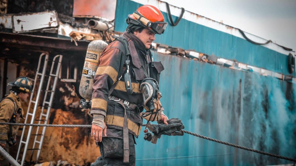 Firefighters in action extinguishing a ship fire in Guayaquil, Ecuador, showcasing bravery and teamwork.