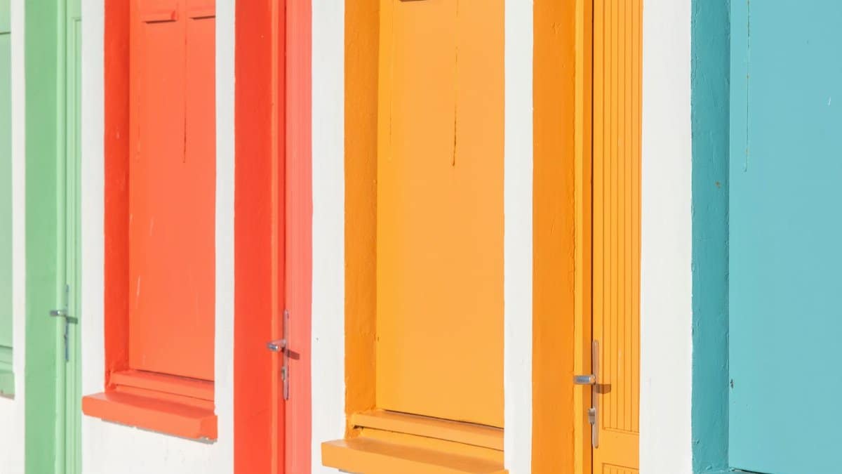 Vibrant closed beach hut doors in bright summer colors, perfect for travel and architectural themes.