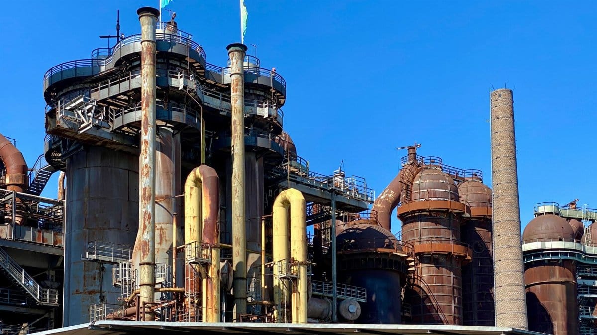 A view of the historic Völklingen Ironworks industrial facility under a clear blue sky.