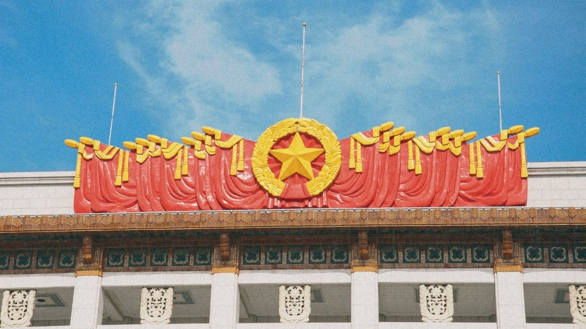 Majestic government facade featuring red star emblem and intricate architecture under blue skies.