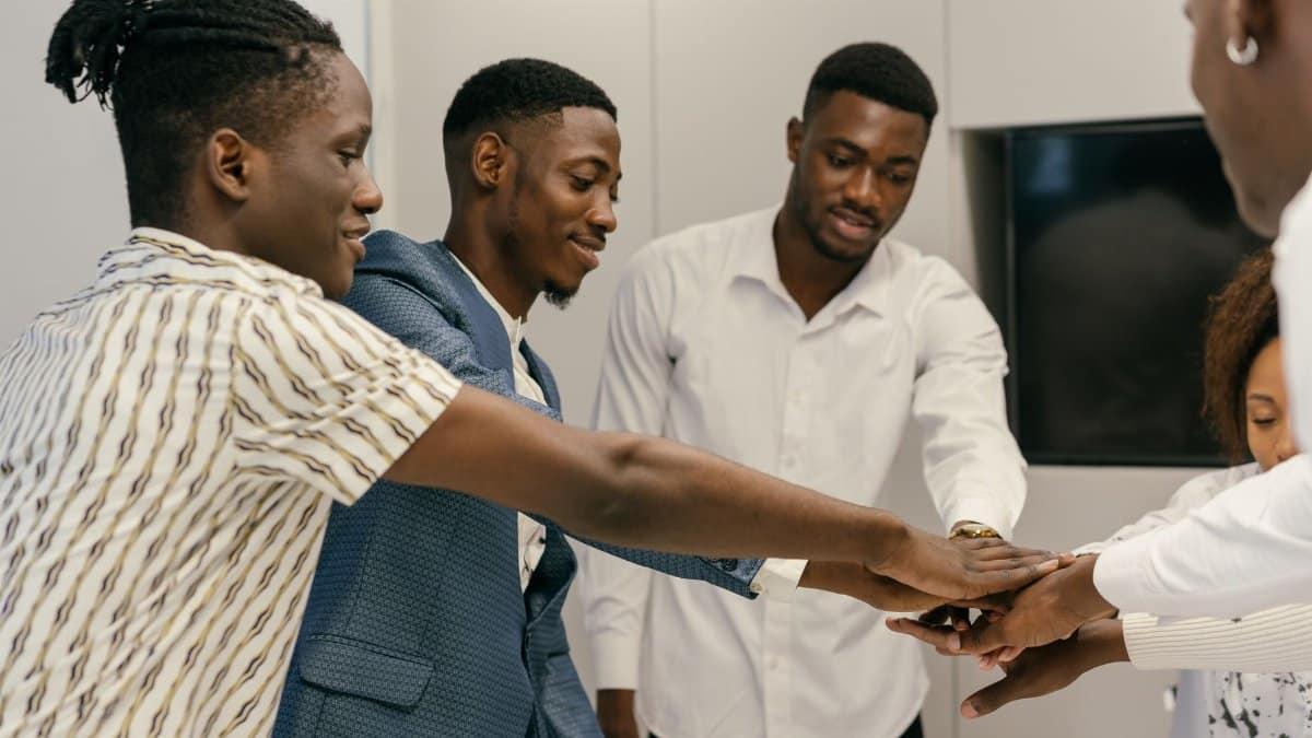 A diverse group of professionals engaging in a team-building exercise in an office environment.