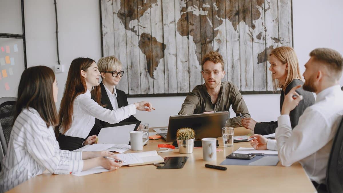 Business team discussing a project around a table indoors.