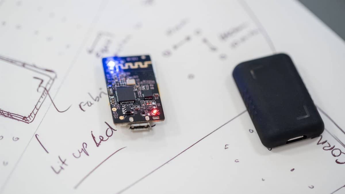 Close-up of a microprocessor and circuit board placed on technical design sketches.