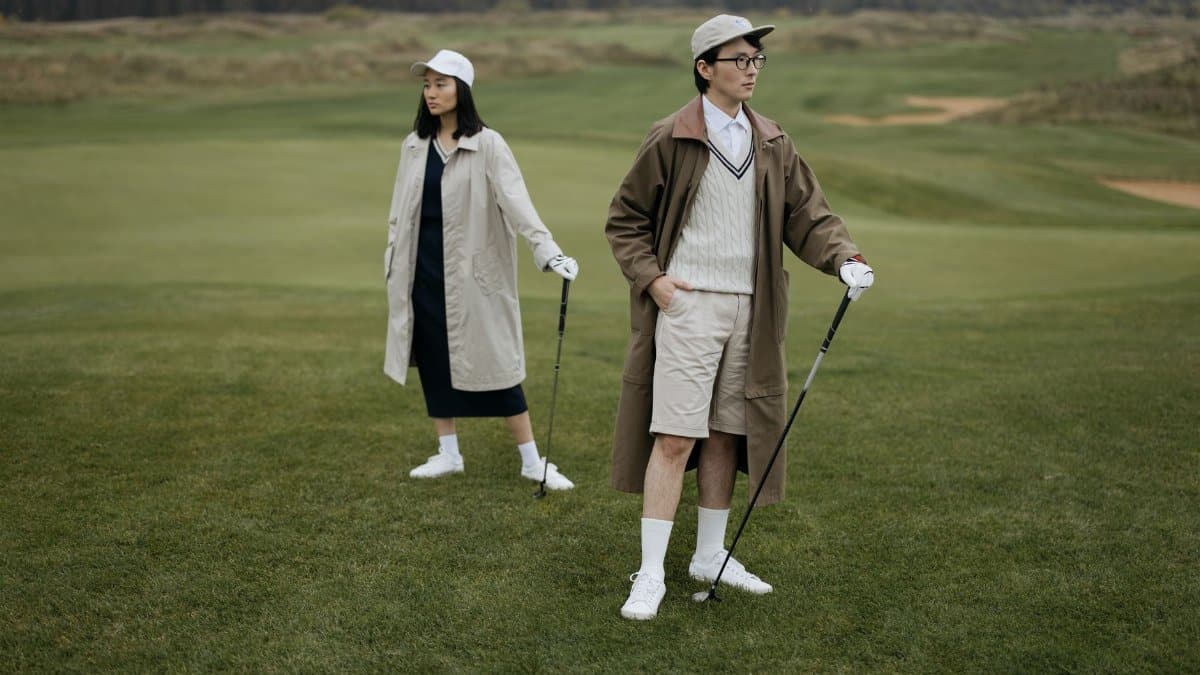 Fashionable young golfers on a lush course, embodying modern style and sport.