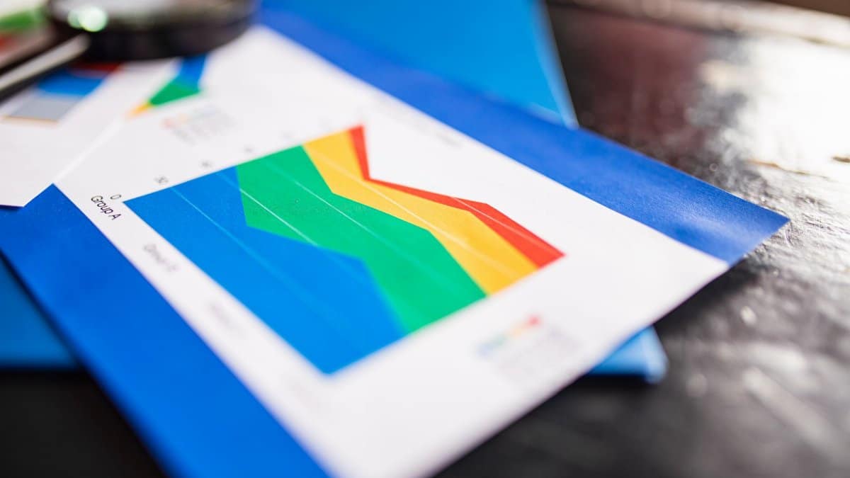 Close-up of a colorful business chart placed on a table with documents highlighting trends.