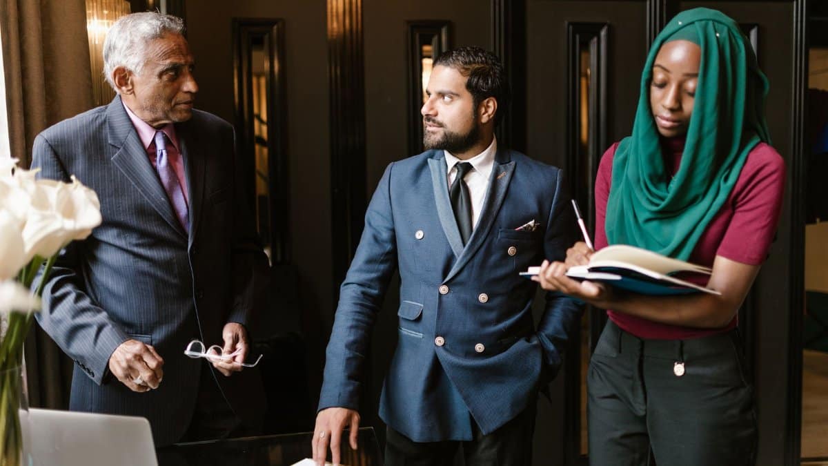 A culturally diverse team engaged in a serious business discussion in an office setting.