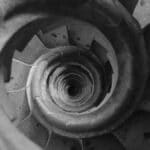 Top view of a spiral staircase in a historic Barcelona building, showcasing geometric patterns.
