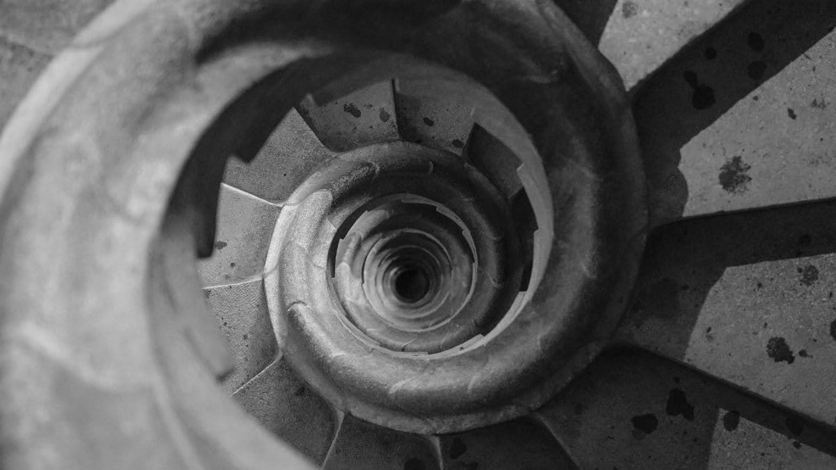 Top view of a spiral staircase in a historic Barcelona building, showcasing geometric patterns.