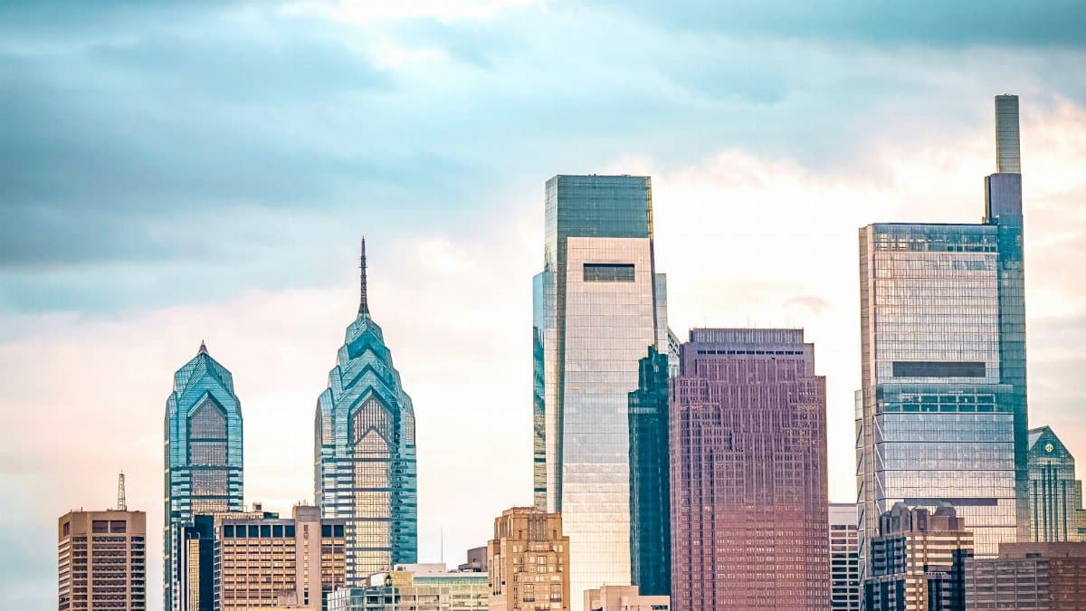 Vibrant Philadelphia skyline featuring iconic skyscrapers under a cloudy sky.