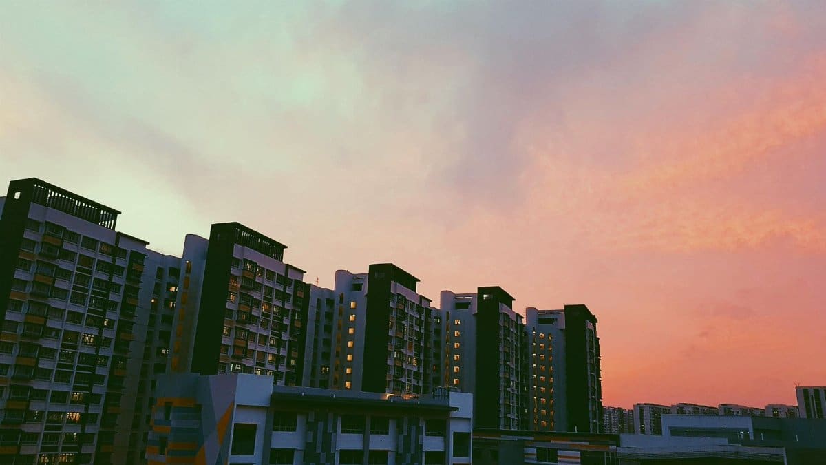 Beautiful high-rise buildings in Singapore under a vibrant sunset sky.