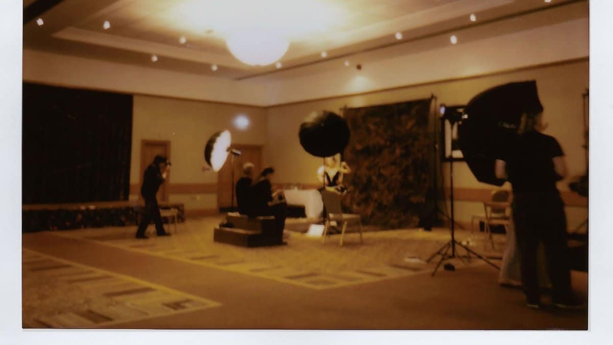 Indoor studio setup with professional lighting and crew at work. Ideal for creative projects.