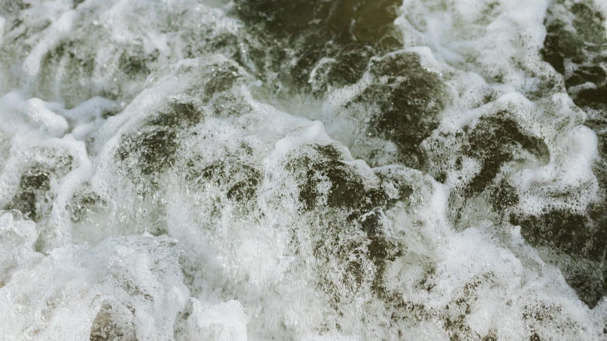 Powerful ocean waves creating sea foam in a close-up shot, capturing the energy and movement of the sea.