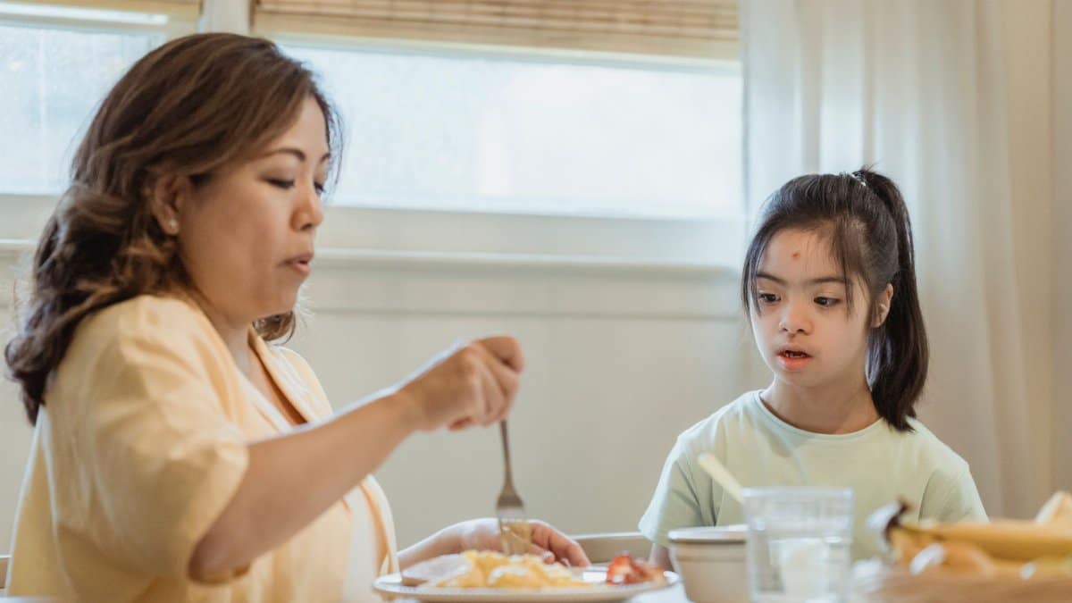 A mother and daughter share a peaceful breakfast at home, highlighting family bonding.