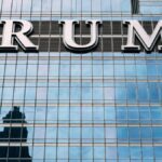 Close-up of Trump Tower's glass facade with the city skyline reflection in the windows.