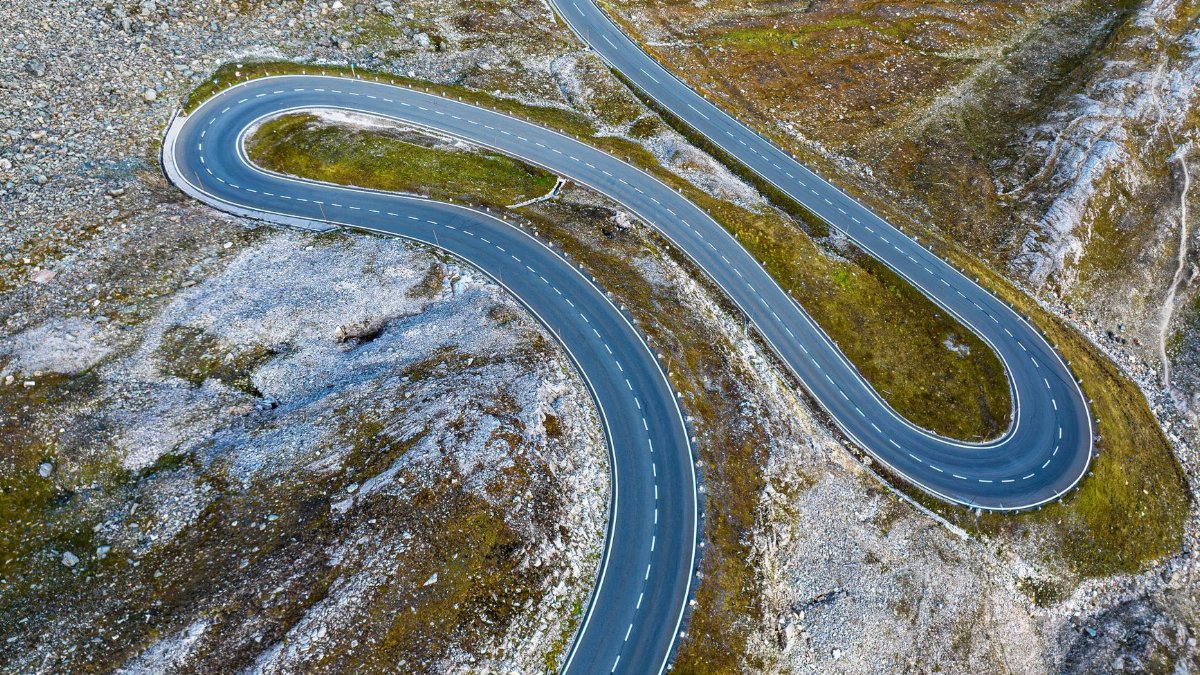 Scenic aerial view of a winding mountain road in Hochtor, Oberösterreich.
