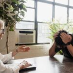 A client expressing distress in a counseling session with a therapist, focusing on mental health support.