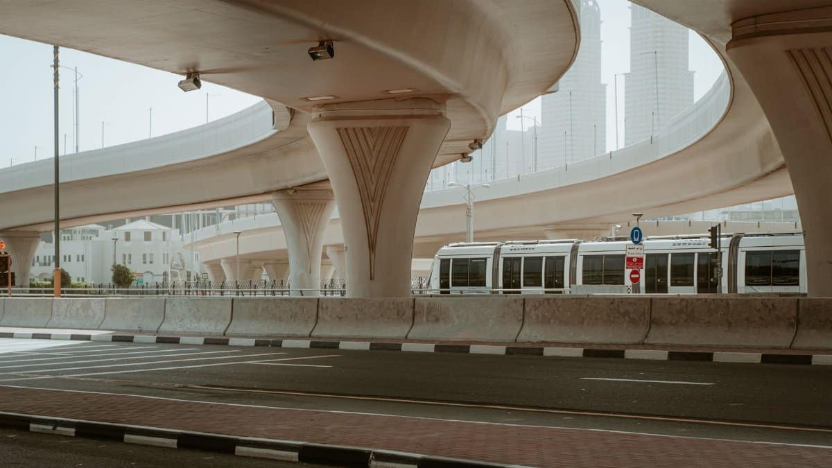 A modern overpass and metro in Dubai's urban landscape showcasing transportation infrastructure.