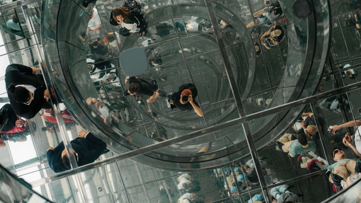 A stunning view of reflections and modern architecture at Summit One Vanderbilt in NYC.